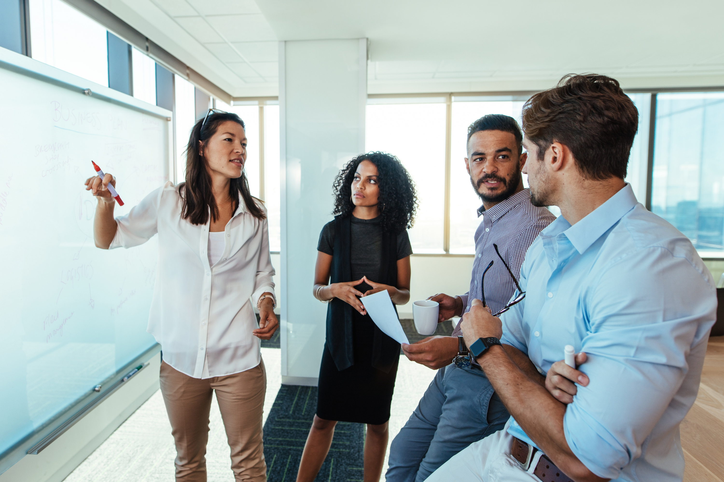 Four individuals discussing and engaged in Strategic Planning Process