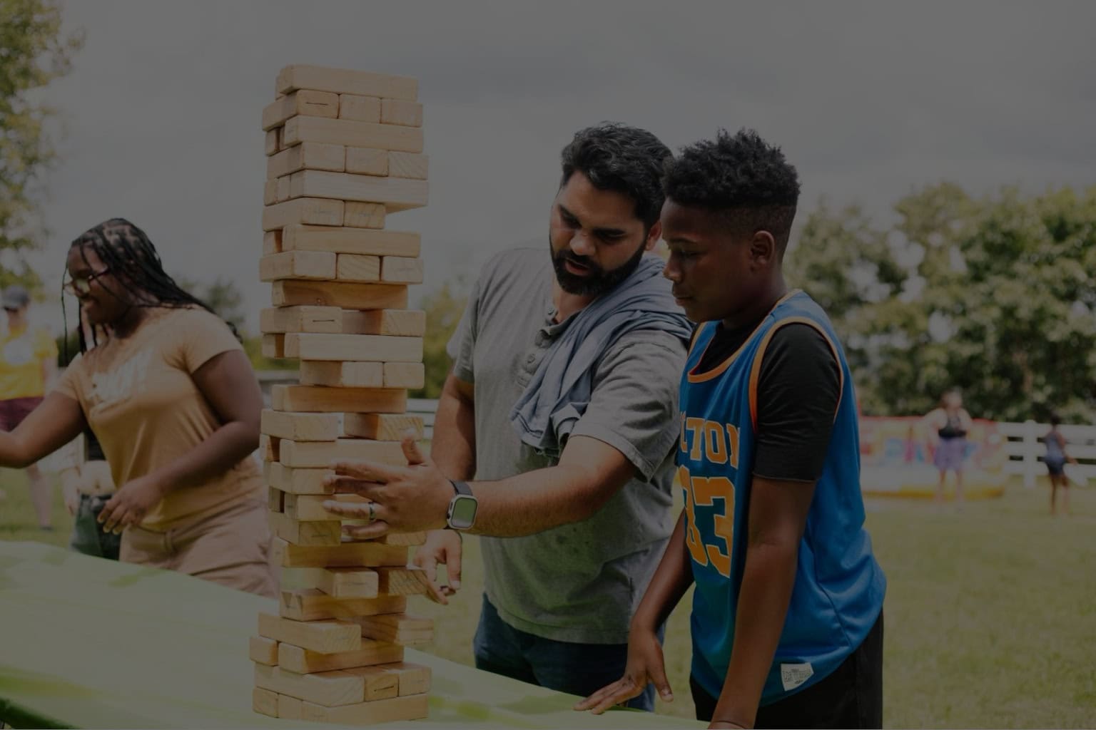 Photo of volunteer engaging with a student at an event for Big Brothers Big Sisters of Central Carolinas to showcase Carter's governance services.