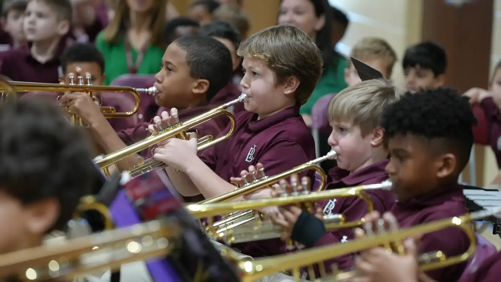 Young students playing trumpets in a school band, focusing on music education and student musical activities at Boys' Latin School, a Carter Partner.