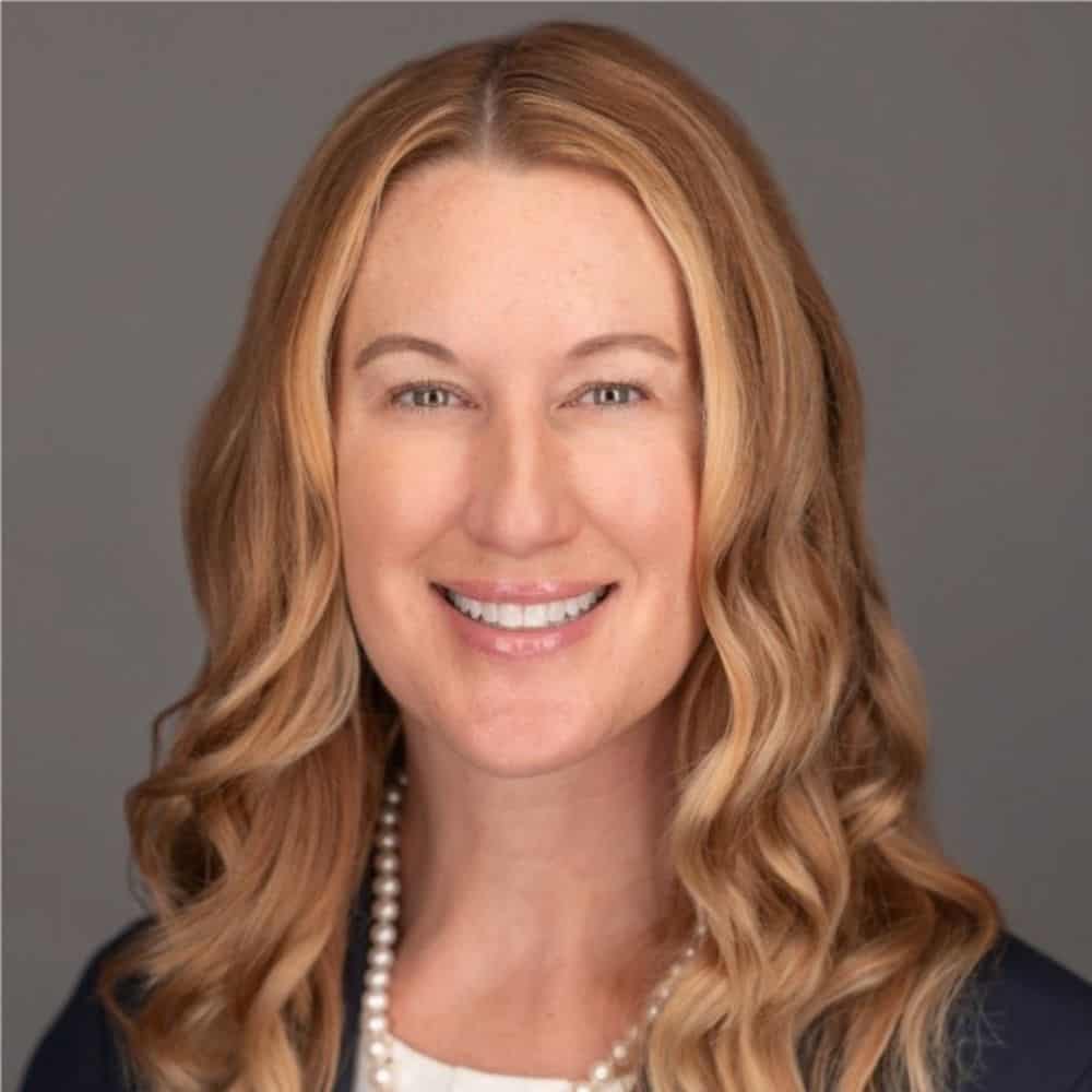 Red-haired woman smiling, professional headshot for Carter 2025 initiative, showcasing leadership, confidence, and community engagement.