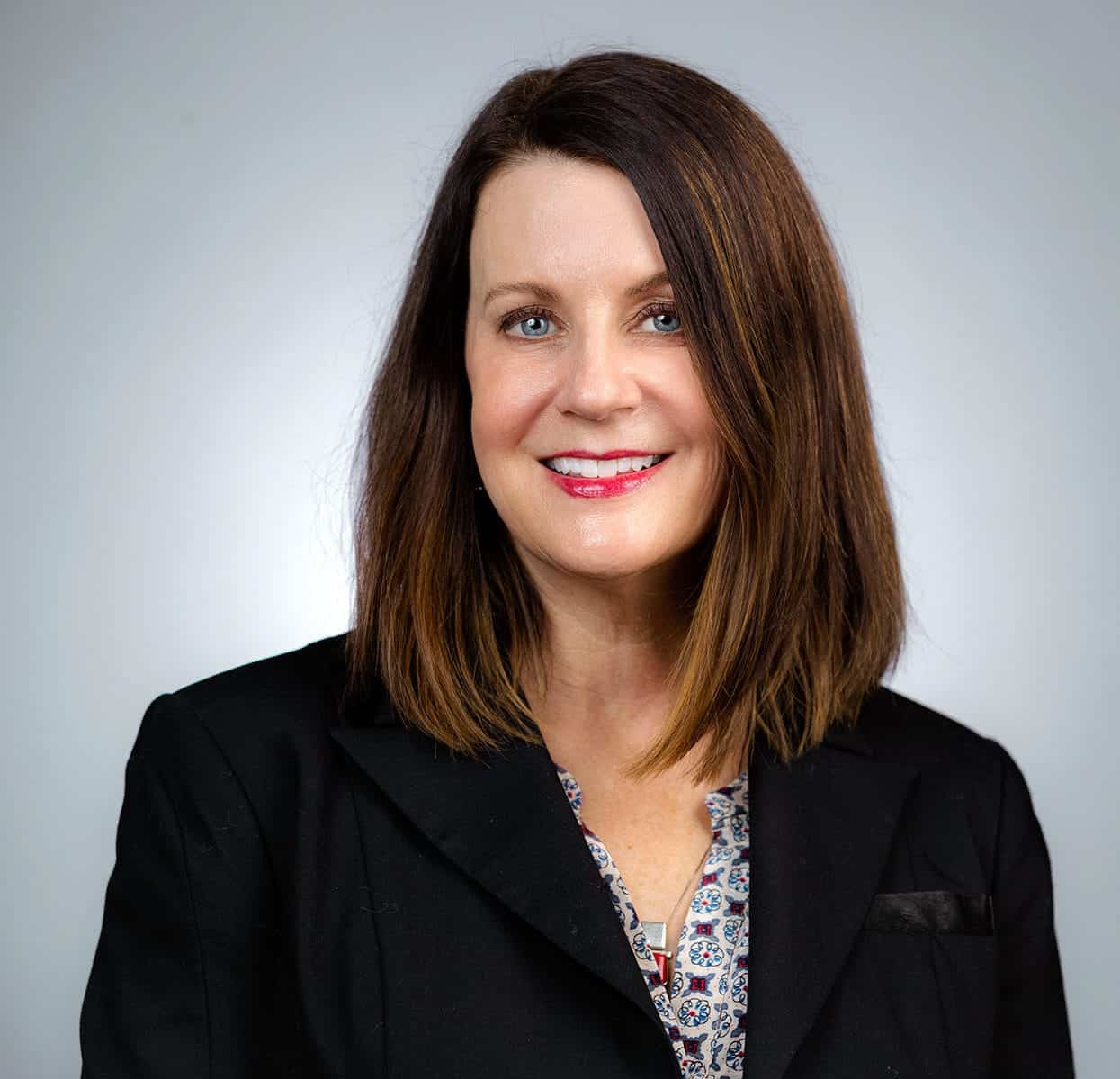 Professional woman portrait, business attire, smiling and confident.