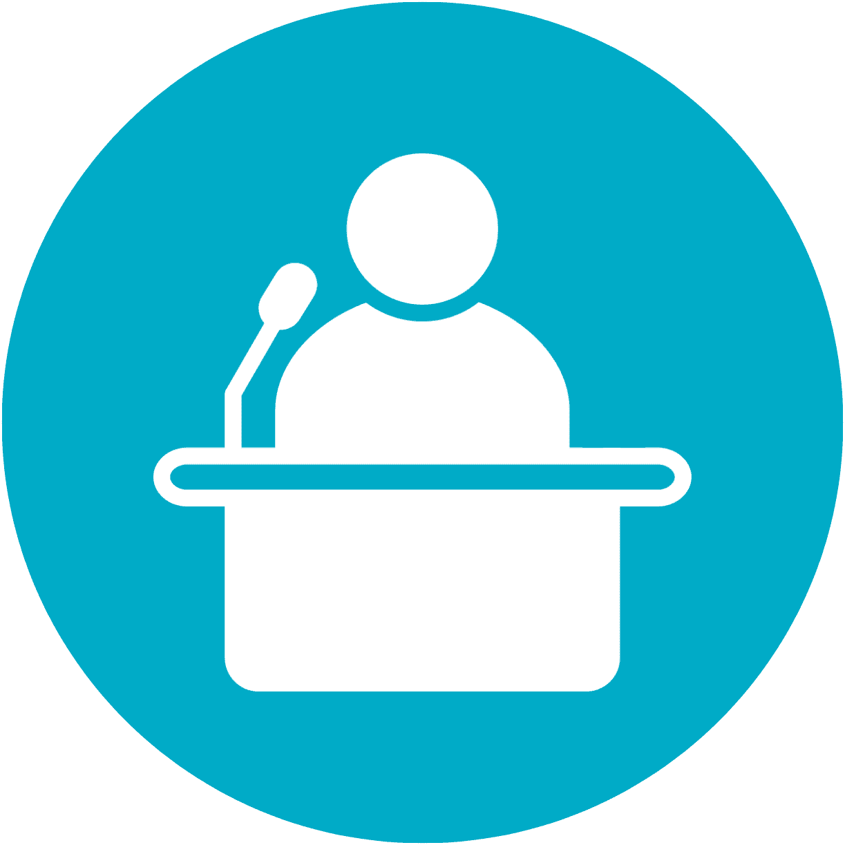 Man speaking at a podium with a microphone, representing a political or public speech event.